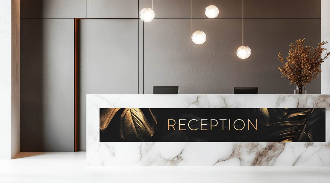 Eine Folie mit Beschriftung, die an einer Rezeption angebracht ist.